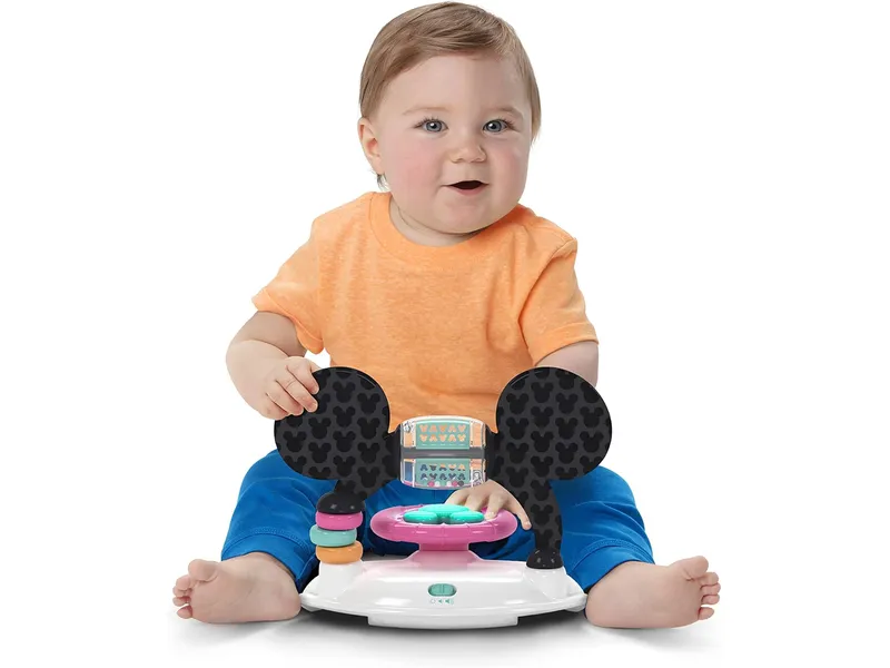 baby playing with detached toy from minnie mouse Walker