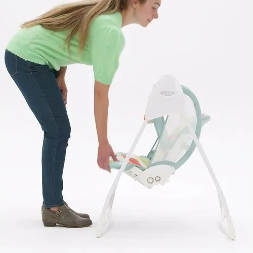 mother bending over graco baby delight swing