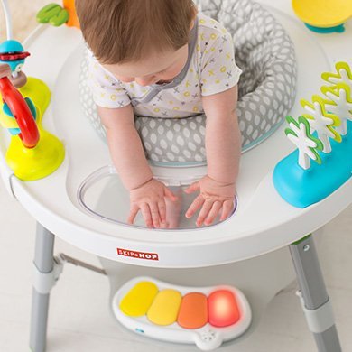 infant playing with the The Skip Hop Explore & More Baby’s View 3-Stage Activity Centre