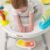 infant playing with the The Skip Hop Explore & More Baby’s View 3-Stage Activity Centre